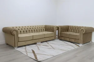 Elegant Chesterfield 3+2 seater sofa in beige plush velvet with deep button tufting, wooden legs, and a classic curved arm design