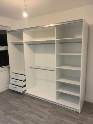 Interior of Milan 250cm wardrobe featuring 6 shelves, 2 hanging rails, and 3 drawers for maximum organization