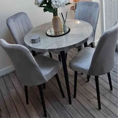 UK size light grey velvet dining chairs paired with round marble-look table