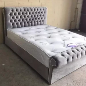 Modern sleigh bed with optional storage in grey silver, pink, blue, and black – available in the UK.